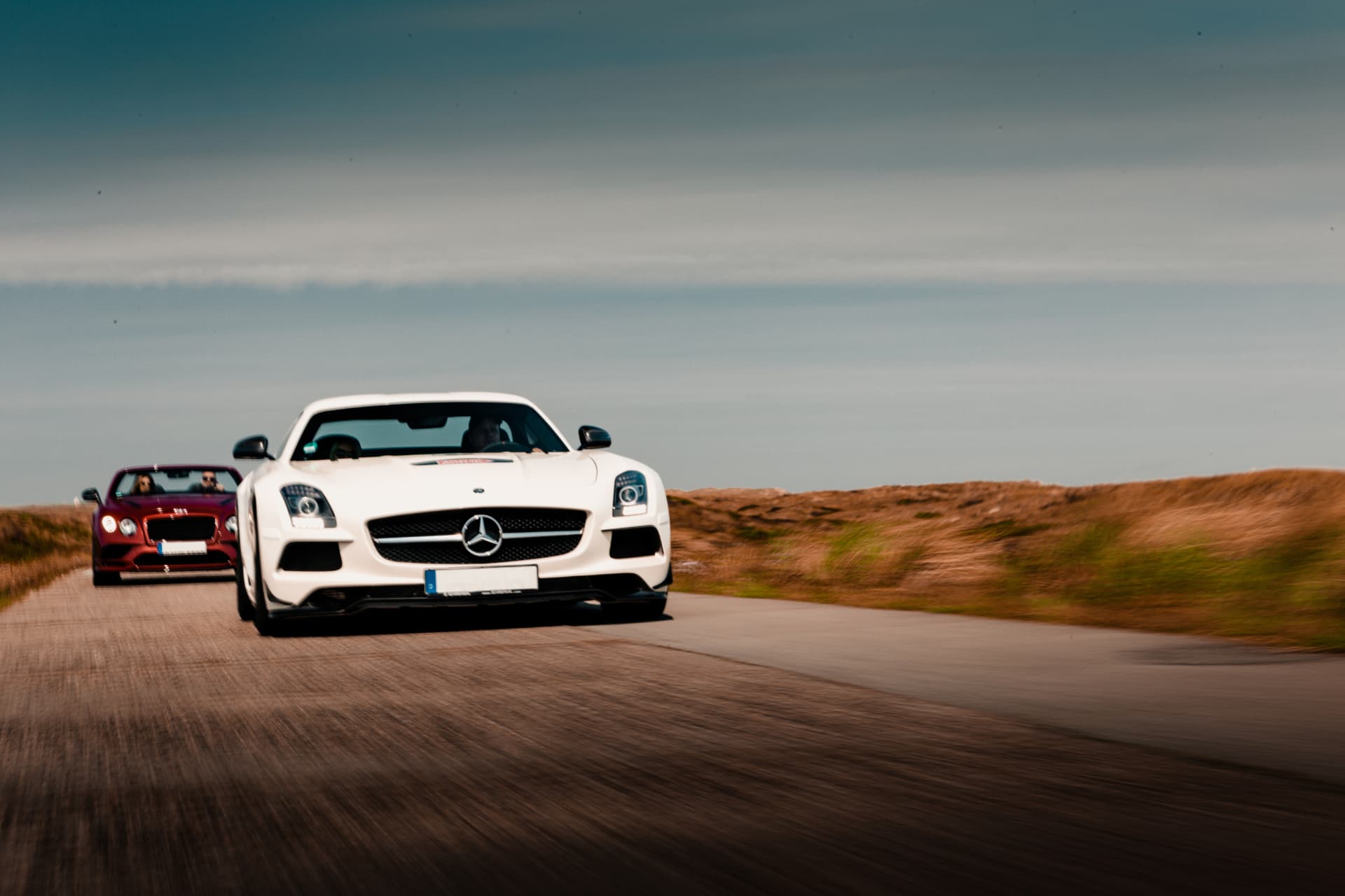 A sports car on an alpine road at first light
